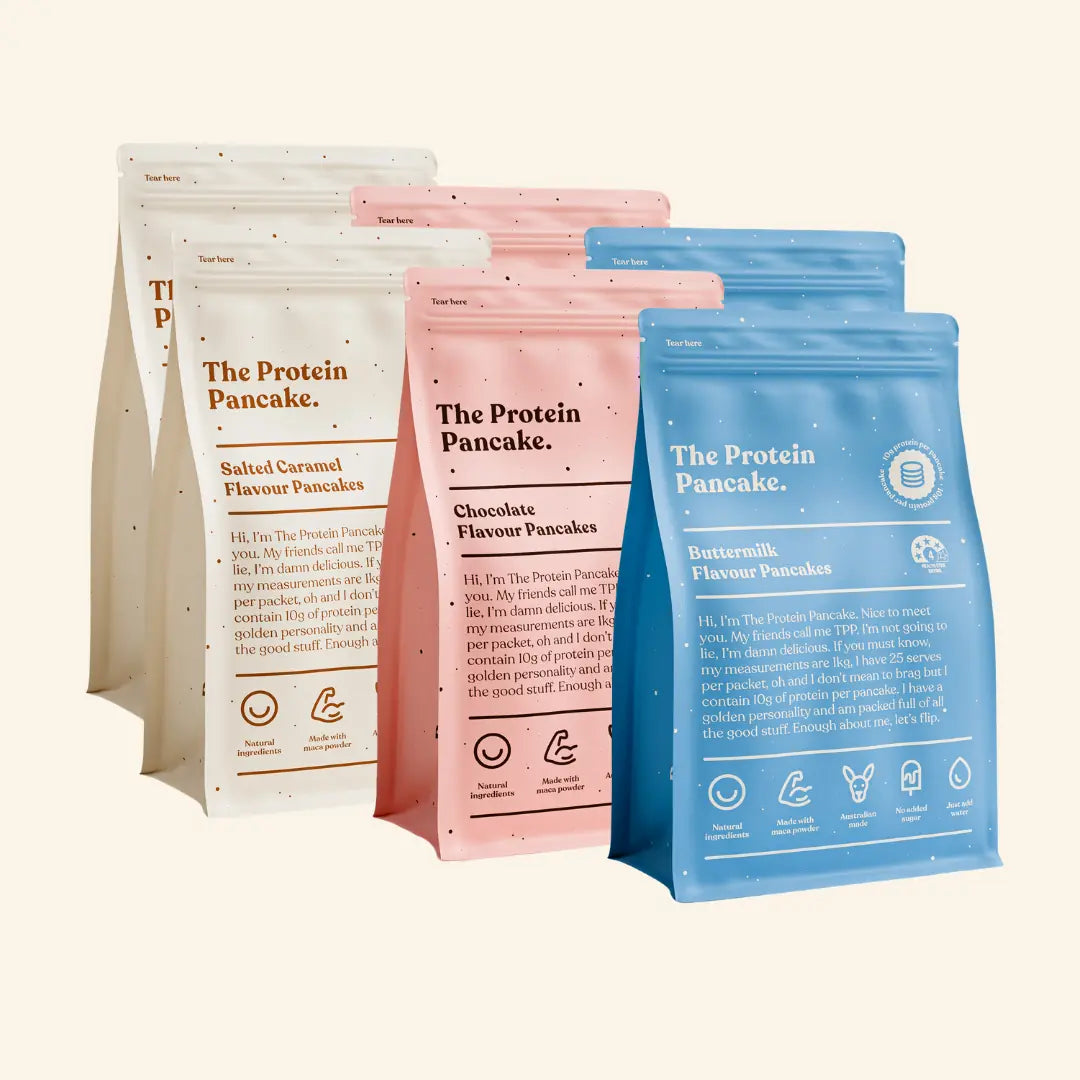 Various flavored protein pancake mix packages: salted caramel, chocolate, and buttermilk.