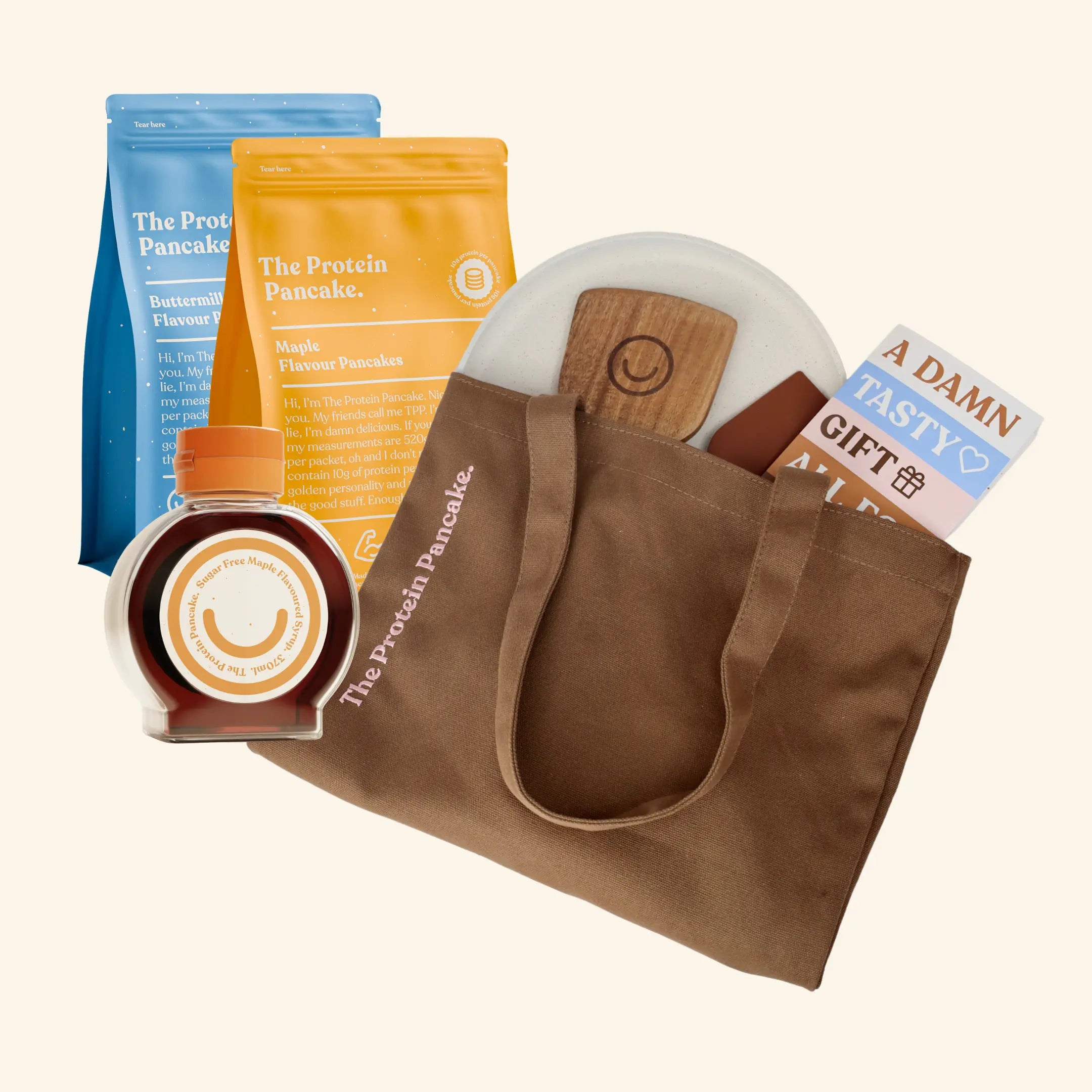 Three colorful packages of The Protein Pancake in various flavors.