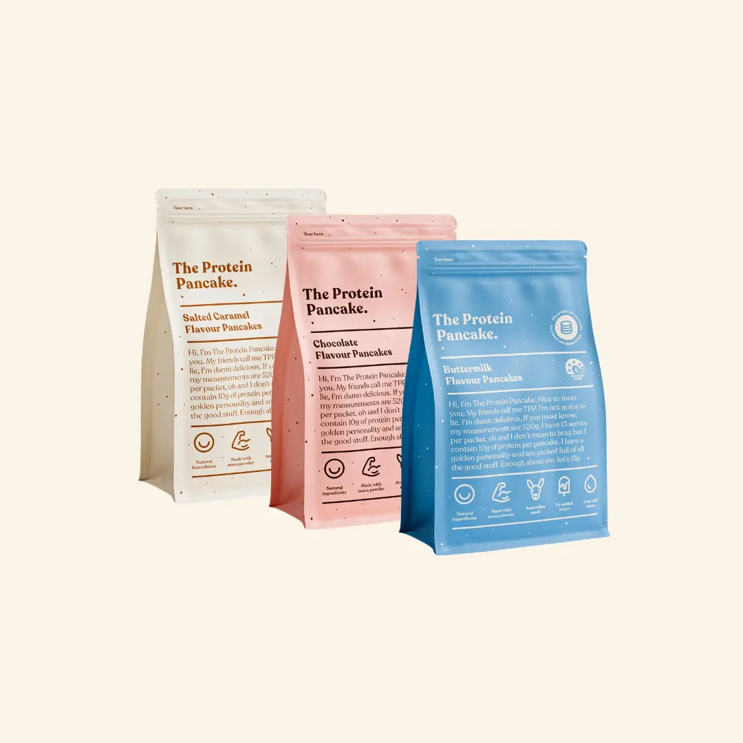 Three bags of flavored protein pancake mix: salted caramel, chocolate, and buttermilk.